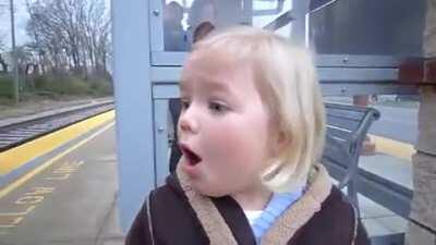 little girl very excited to see train for first time