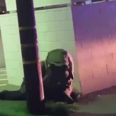 They secluded him behind a wall and looked around to see if anyone was watching so they can beat him... this is why we protest