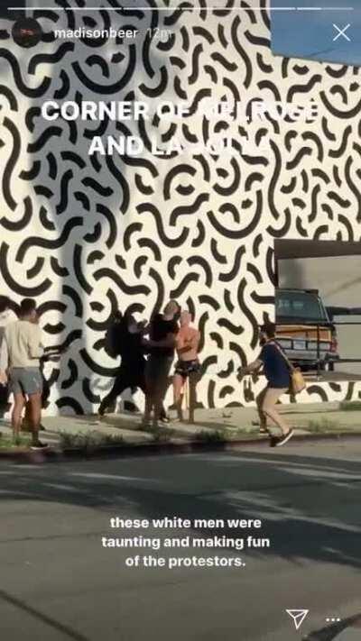 Guy taunts protesters and proceeds to get knocked out