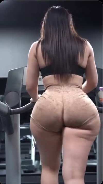 Thicc girl in beige shorts walking on treadmill
