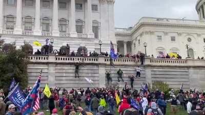 People are climbing the walls of the Capitol