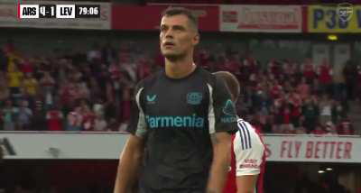 Granit Xhaka gets a standing ovation from the Emirates Stadium and shares a hug with Mikel Arteta as he leaves the pitch.