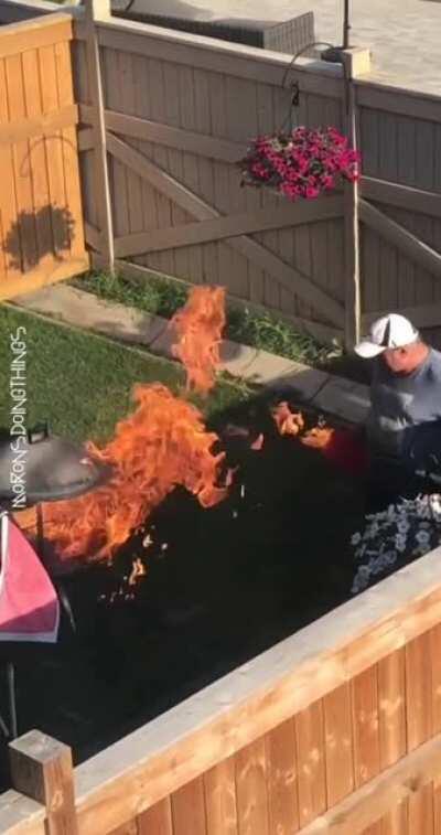 Guy tries adding fuel to the fire with an open jerry can
