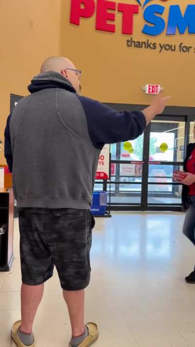 Small child having a tantrum over a wrong price tag while employee is trying to match the price