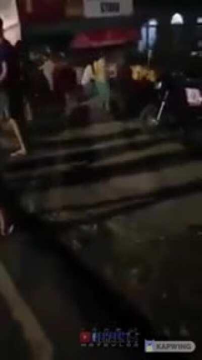 Dancing pedestrian hit by high-speed motorbike in the middle of the highway during New Year's Eve celebration