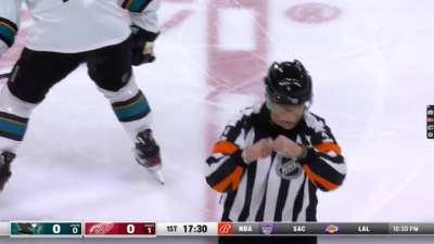 NHL Referee gives a fighting call with some flair