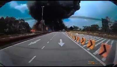 Dash cam footage taken from a car passing by the scene of a crashed private jet in Shah Alam, Malaysia