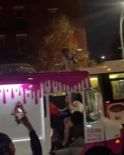 Guy on top of a bus with a flame thrower...