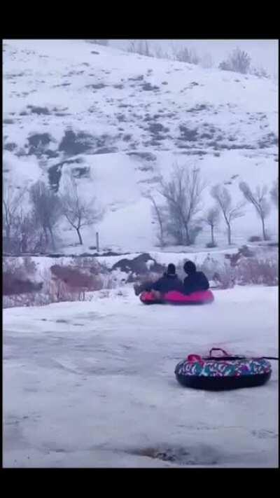 Downhill tubing fun results in people going airborne