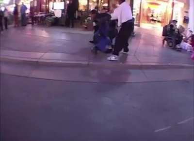 Fighting in an Outdoor Mall while Guitar Man Plays