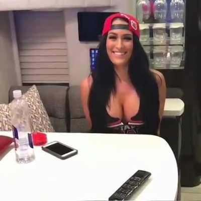 Nikki Bella presses her big tits against the table