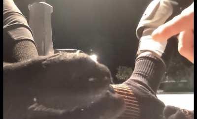 two roller derby girls taking off their skates together