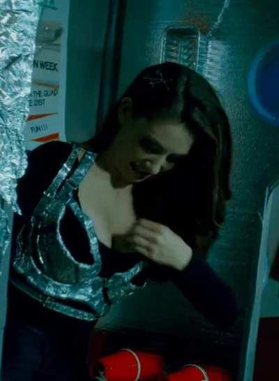 Annie reaches down her shirt