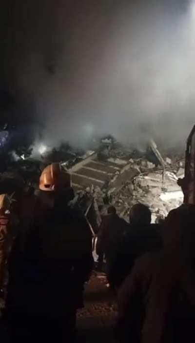 In complete silence, rescuers attempt to locate the voice of a woman trapped under debris, after Russia fired a missile at a civilian apartment block in Dnipro today.