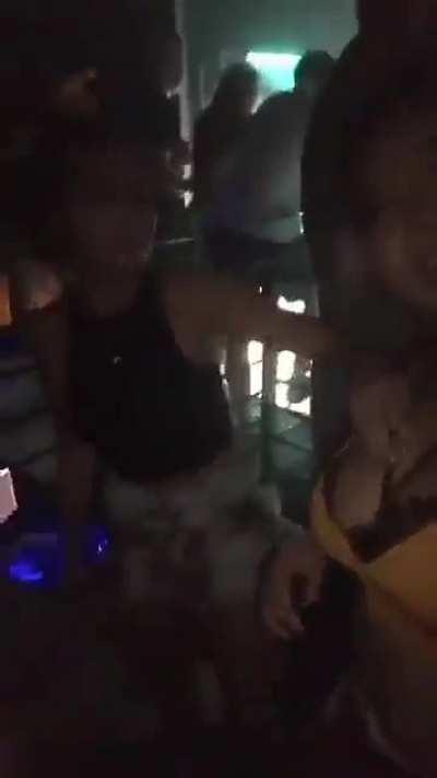 Rubbing ice on her breasts