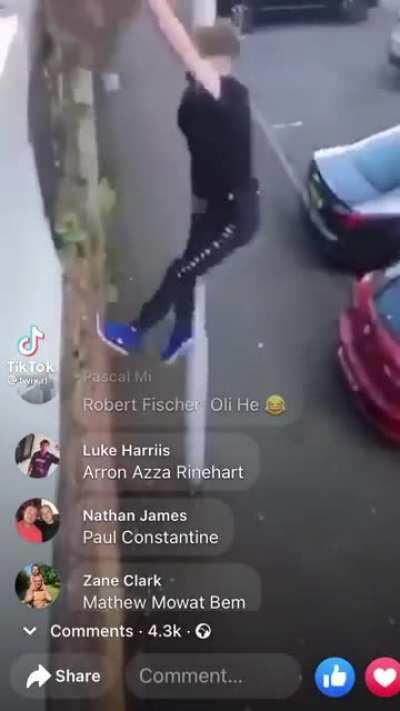 Man climbs stone wall as it breaks a piece and lands on his leg