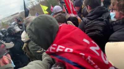 Leaked Parler Video showing insurrectionists fighting with police outside Capitol, while calling them traitors.