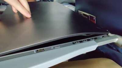 New laptop fits perfectly under the back of the seat in front on the airplane