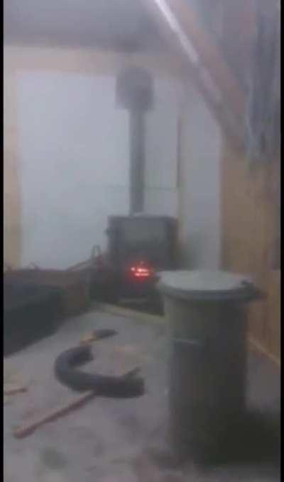 2 dudes putting a spray can in the oven