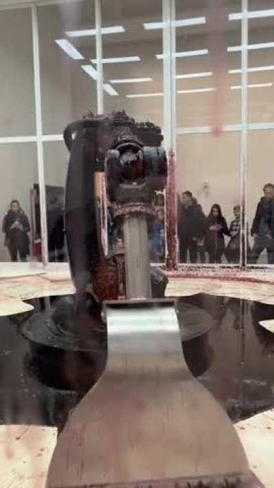 an art installation where the machine is leaking hydraulic fluid. it's trying to keep it inside, but the leak will kill it anyway. @nicwashere