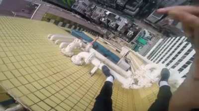 World renowned free solo climber climbs the outside of a skyscraper POV