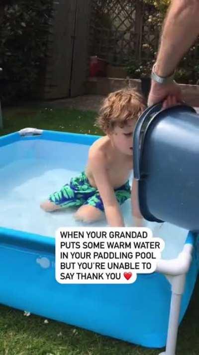 This little boy, who is unable to speak, says thank you after his grandfather put hot water in the paddling pool.