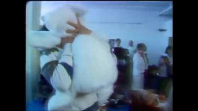 Young Keanu Reeves playing with teddy bear