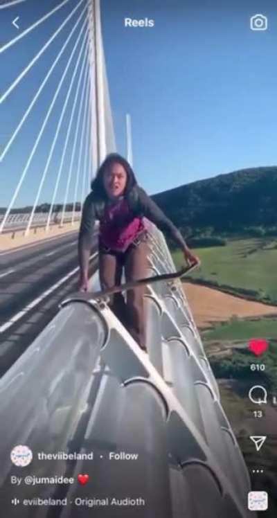 Man skateboards off of bridge