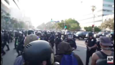 LAPD officers threatening to fire less-than-lethal rounds from close range on peaceful protestors