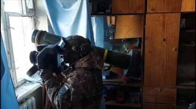 A Ukrainian soldier fires from a Javelin indoors.