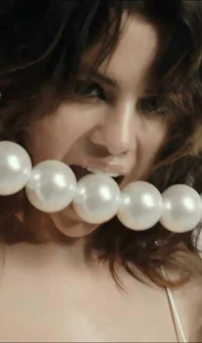 Selena Gomez trying to gag on some balls
