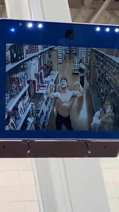 Muscle man flexing in store camera. Cringe or gigachad?