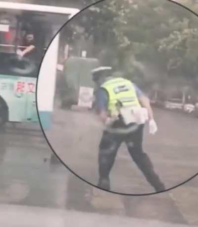 A passenger giving his umbrella to the traffic police on a rainy day :)