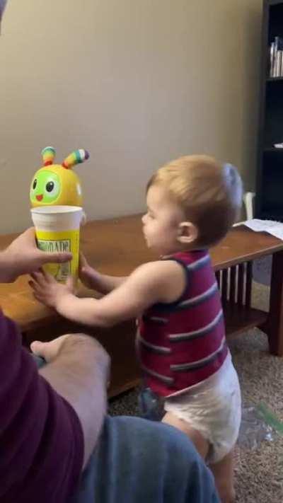 Kid tries drinking water from cup [found in r/funny]