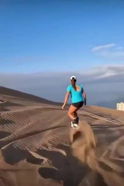 A combination of a city skyline and massive sand dunes.