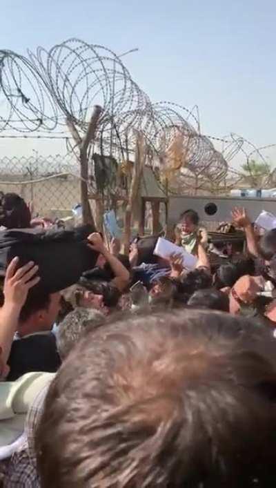 Afghans handing off their babies to the 82nd at Kabul Airport. Hopefully they get some good homes.