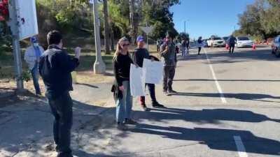 Covid Deniers and Anti-maskers heckeling people waiting to get vaccinated a Dodge Stadium, Los Angeles