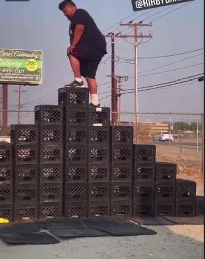 WCGW trying to stand on a very high stack of crates?