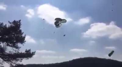 U.S attempts to airdrop humvees which leads to multiple accidentally falling out of their parachutes into the ground