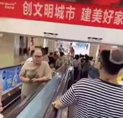 Traditional greeting on an escalator