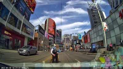 Couple walks in the middle of the road on a green light and start kissing