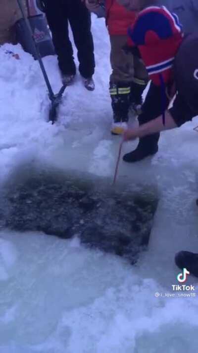Canadian lost his phone in a frozen lake, so he goes looking for it