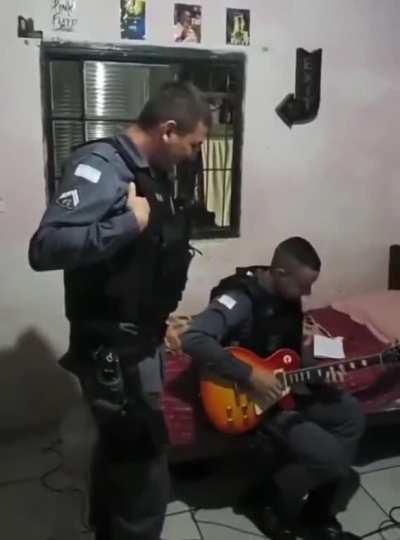 Brazilian cop playing suspect's electric guitar