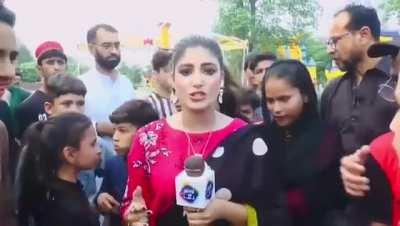Pakistani news correspondent slaps a boy on live TV for interfering with her report!
