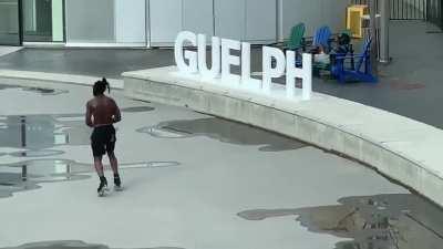 Man dancing on roller skates like nobody is watching outside Guelph city hall