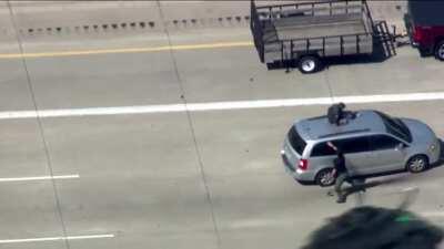 Detroit police tackle suspect off of a minivan after a chase on I-75