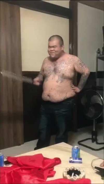 Crazy asian dude sticks knife into his own head