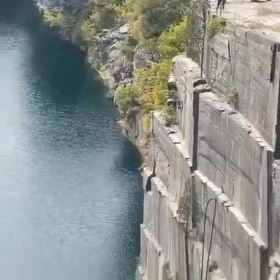 Diver makes a ridiculous and life-threatening jump & flip off of a quarry wall.