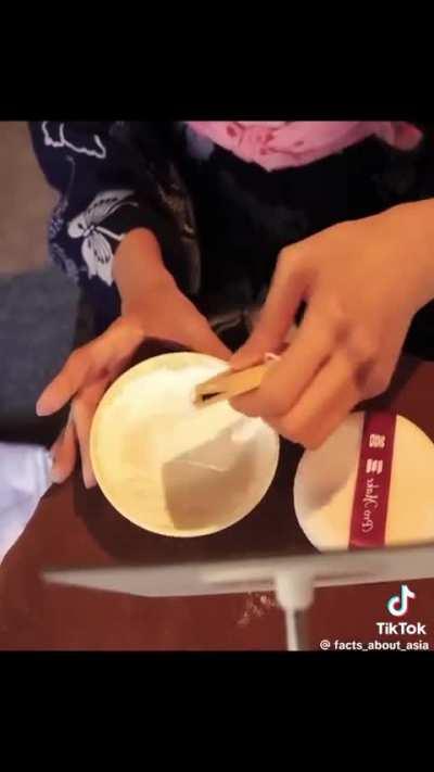 Geisha doing her makeup 