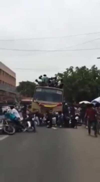 Standing on top of a moving bus